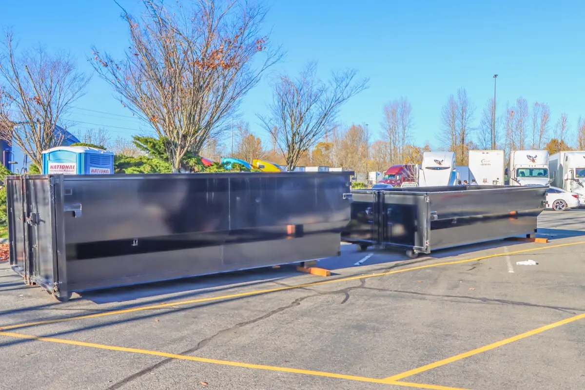 Professional dumpster rental service with roll-off container on residential driveway in Kings Mountain